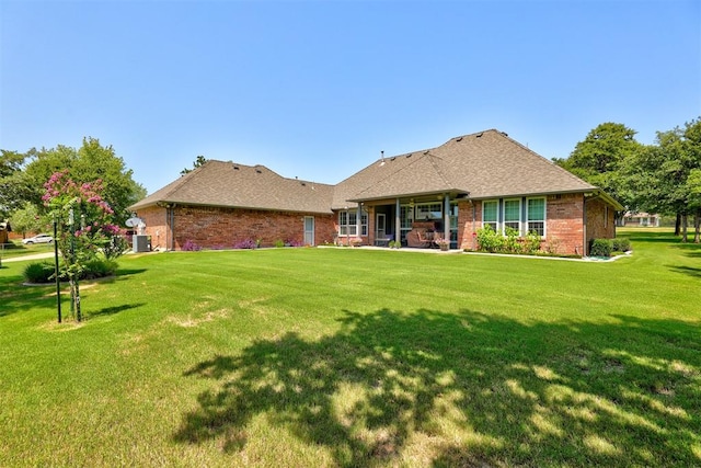 rear view of property featuring a yard