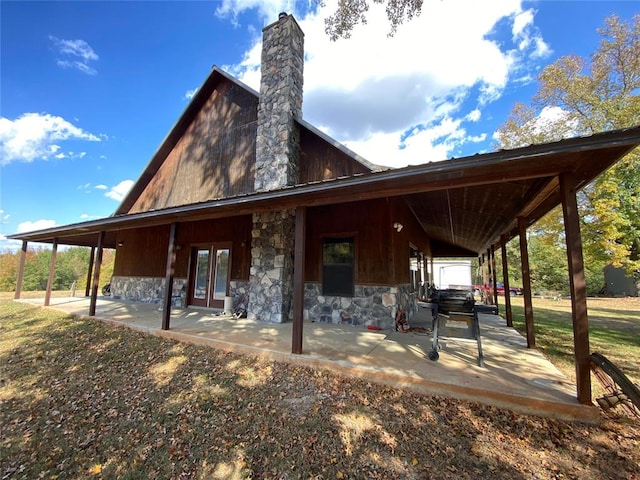 back of property featuring french doors and a patio area