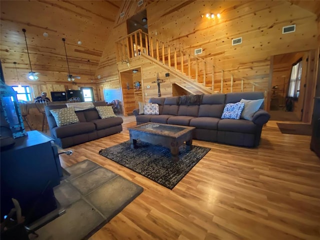 living room with high vaulted ceiling and hardwood / wood-style flooring