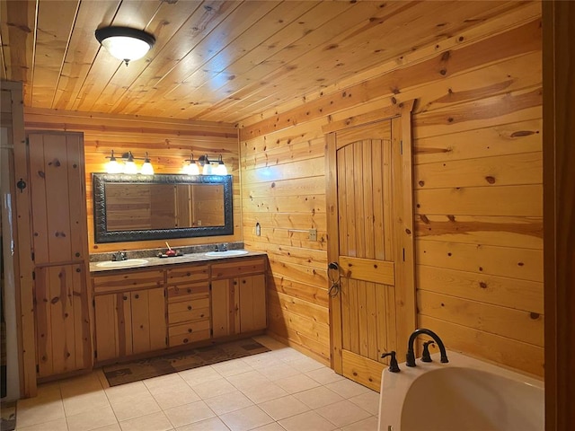 bathroom featuring tile patterned floors, vanity, wooden walls, wooden ceiling, and a bathing tub