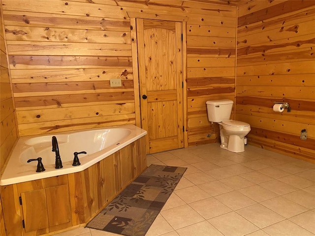 bathroom with tile patterned floors, wooden walls, a tub to relax in, and toilet