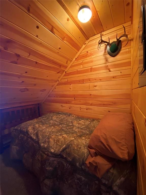 bedroom featuring wood ceiling, wooden walls, and vaulted ceiling