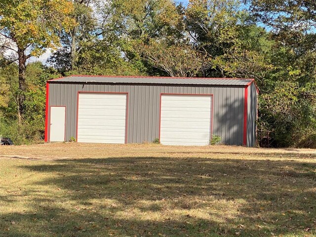 garage featuring a lawn