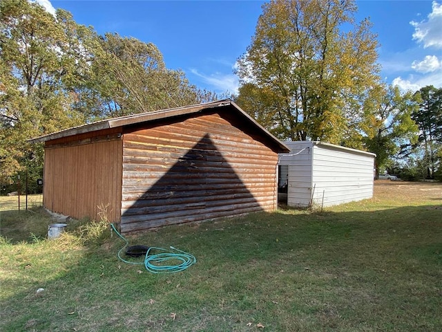 view of outbuilding featuring a yard