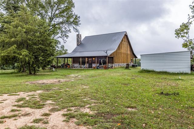 309 Rufe Rd, Valliant, OK 74764 - back of property featuring a yard, a chimney, and an outdoor structure