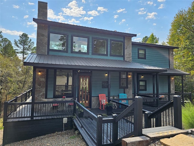 back of house featuring a porch