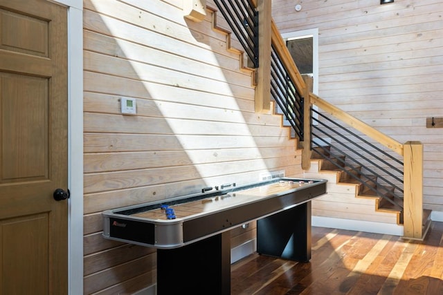 interior space with dark wood-type flooring and wood walls