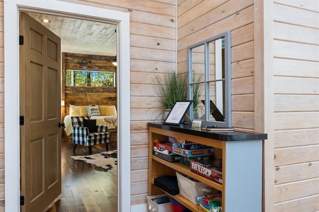 interior space featuring wood walls and dark hardwood / wood-style floors