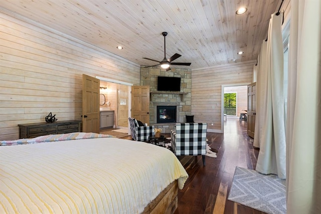 bedroom featuring wood walls, wooden ceiling, a stone fireplace, dark hardwood / wood-style floors, and ceiling fan