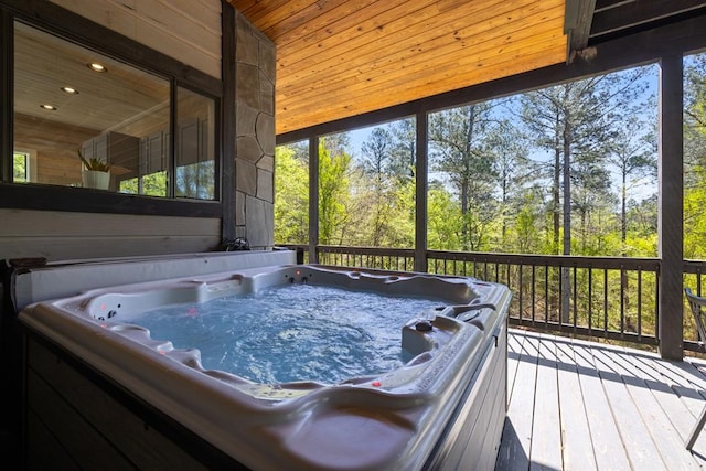 sunroom / solarium with vaulted ceiling, a hot tub, and wood ceiling