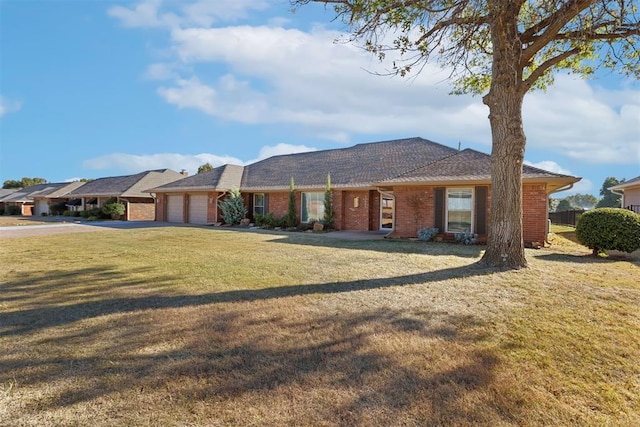 ranch-style home with a front yard and a garage