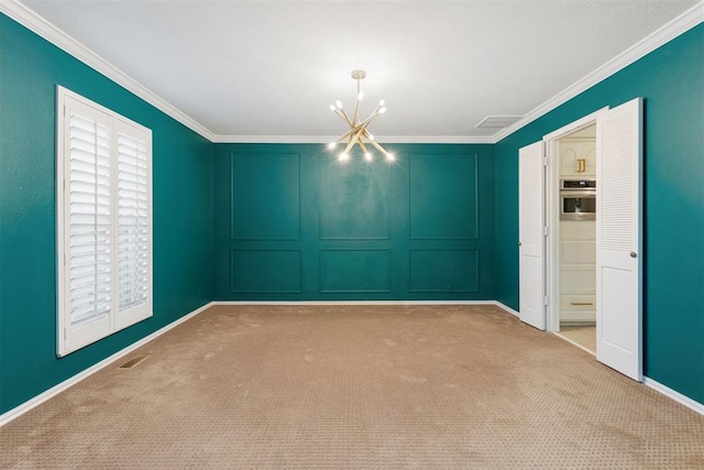 spare room featuring light carpet, crown molding, and an inviting chandelier