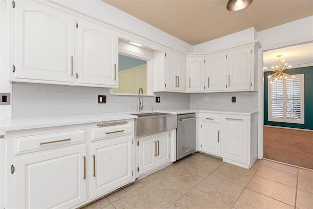 kitchen with sink, light tile patterned floors, tasteful backsplash, stainless steel dishwasher, and white cabinets