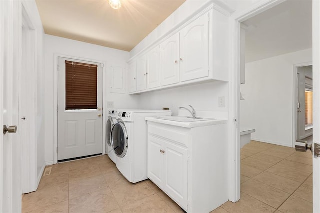 washroom with cabinets, independent washer and dryer, sink, and light tile patterned floors