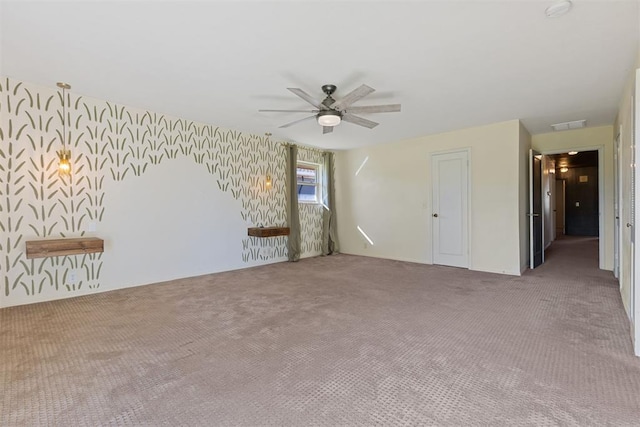 empty room featuring carpet flooring and ceiling fan