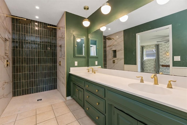 bathroom featuring tile patterned floors, vanity, ceiling fan, and tiled shower