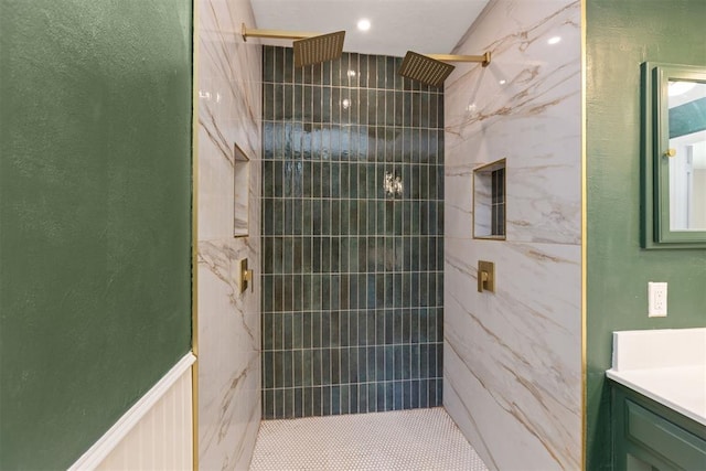 bathroom featuring vanity and tiled shower