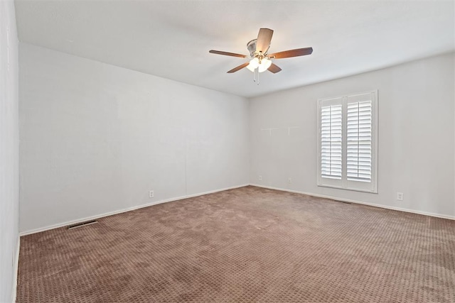 empty room with ceiling fan and carpet floors