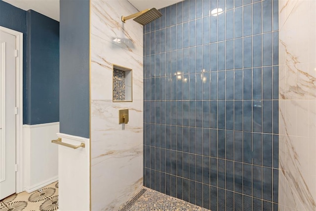 bathroom with tiled shower and tile walls