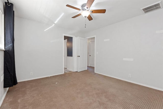 carpeted spare room featuring ceiling fan