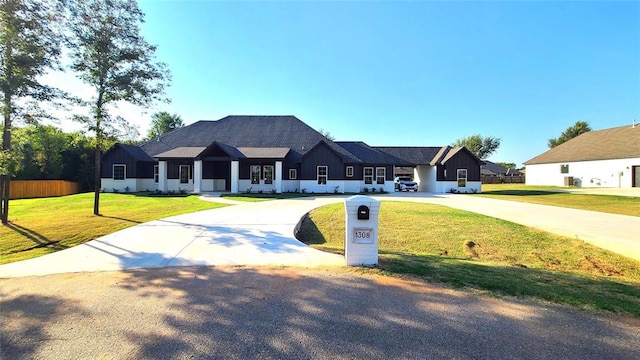 1308 W Harvard Way, Mustang, OK 73064 - view of front of home with curved driveway, board and batten siding, and a front yard