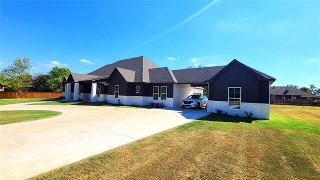 1308 W Harvard Way, Mustang, OK 73064 - view of front of home with curved driveway, board and batten siding, roof with shingles, and brick siding