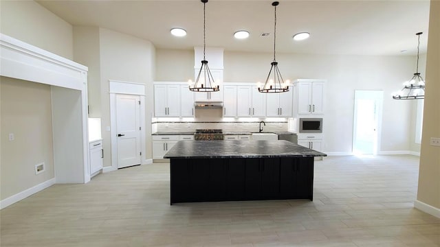 1308 W Harvard Way, Mustang, OK 73064 - kitchen featuring a chandelier, stove, dark countertops, stainless steel microwave, and a sink