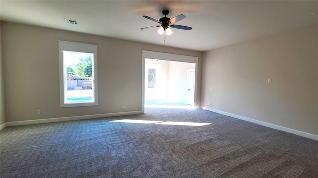 carpeted spare room featuring ceiling fan