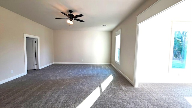 1308 W Harvard Way, Mustang, OK 73064 - unfurnished room with dark colored carpet, ceiling fan, and baseboards