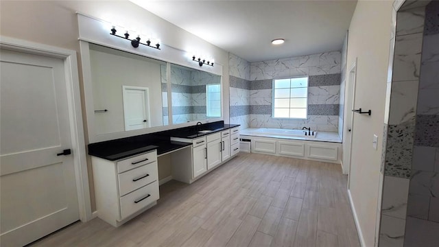 1308 W Harvard Way, Mustang, OK 73064 - full bath featuring a garden tub, vanity, wood finished floors, a walk in shower, and backsplash