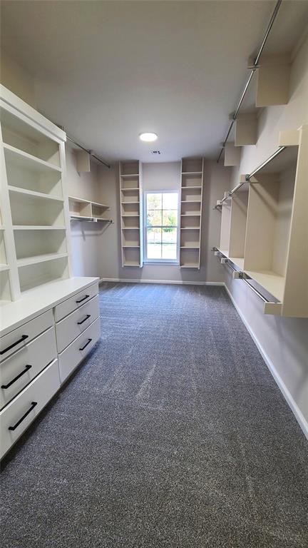 1308 W Harvard Way, Mustang, OK 73064 - spacious closet with dark colored carpet