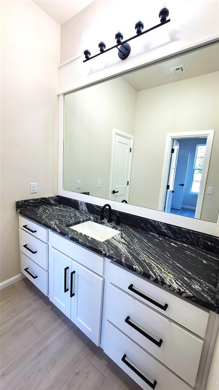 bathroom featuring vanity and hardwood / wood-style flooring