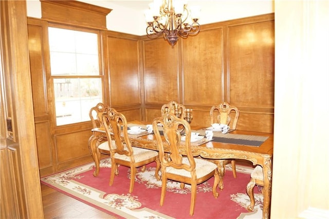 dining area featuring hardwood / wood-style floors and a chandelier