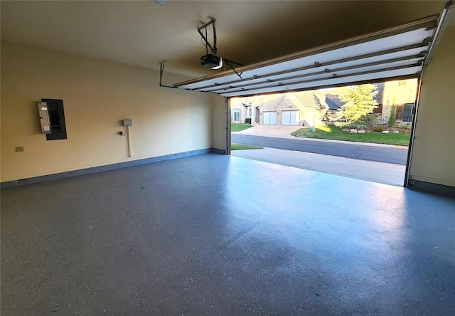 garage with a garage door opener and electric panel