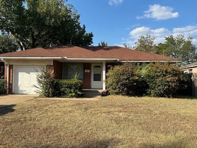 ranch-style home with a garage and a front lawn