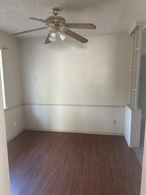 unfurnished room featuring dark hardwood / wood-style flooring, a textured ceiling, and ceiling fan