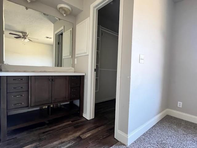 bathroom featuring wood-type flooring, vanity, and ceiling fan