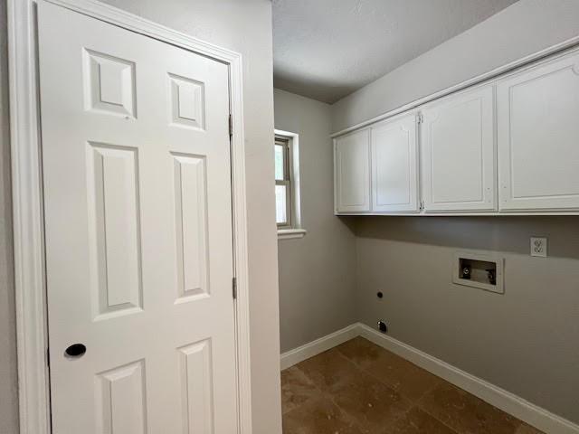 laundry area with electric dryer hookup, cabinets, and hookup for a washing machine