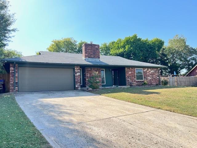 single story home featuring a front yard and a garage