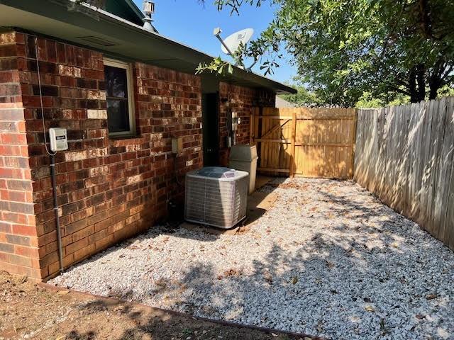 view of side of home with central air condition unit