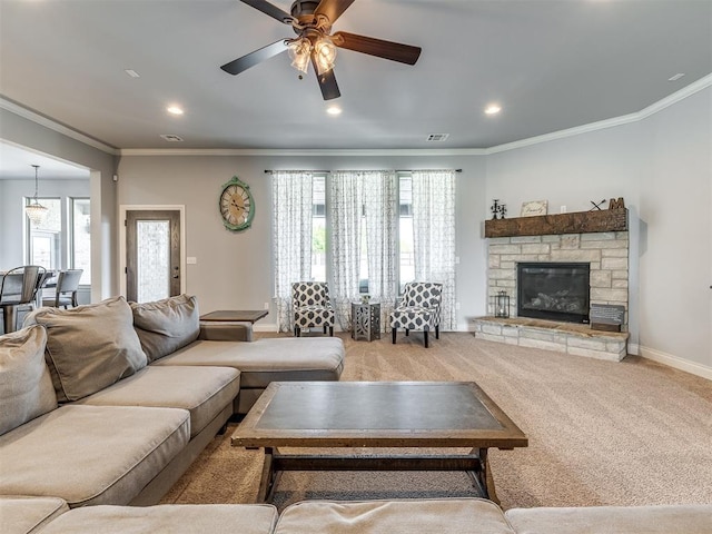 carpeted living room with crown molding and a wealth of natural light