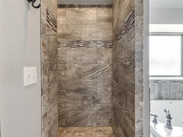 bathroom with tiled shower