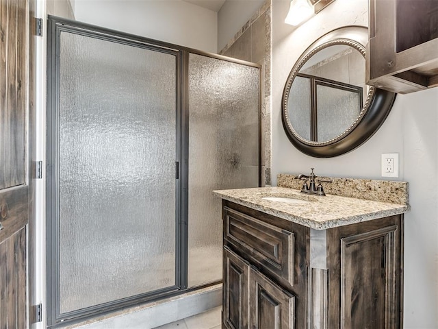 bathroom with tile patterned flooring, vanity, and a shower with shower door