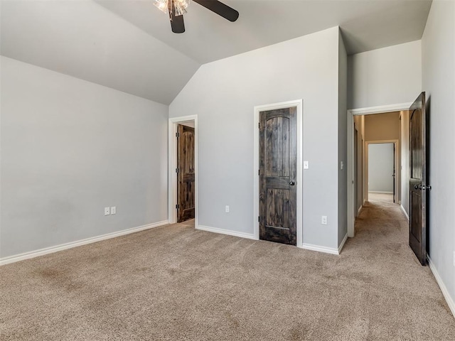 unfurnished bedroom featuring ceiling fan, light carpet, and vaulted ceiling