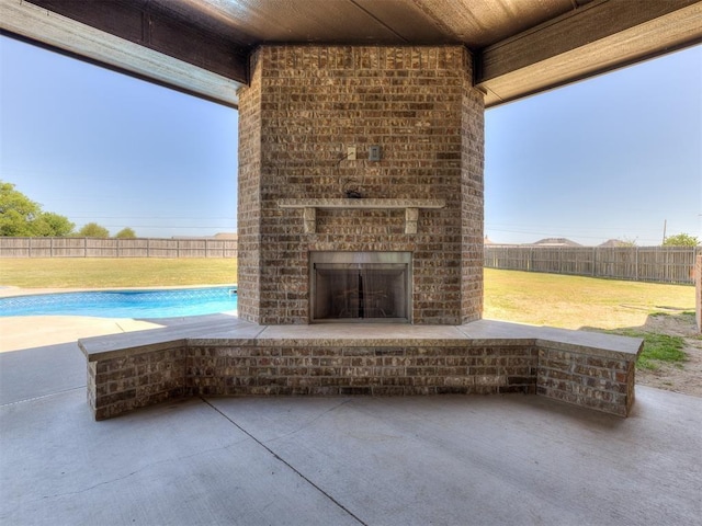 view of patio / terrace featuring an outdoor brick fireplace