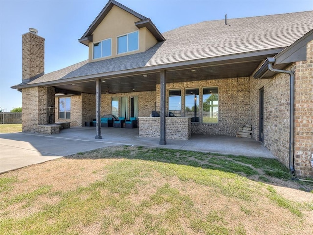 rear view of house with a lawn and a patio area