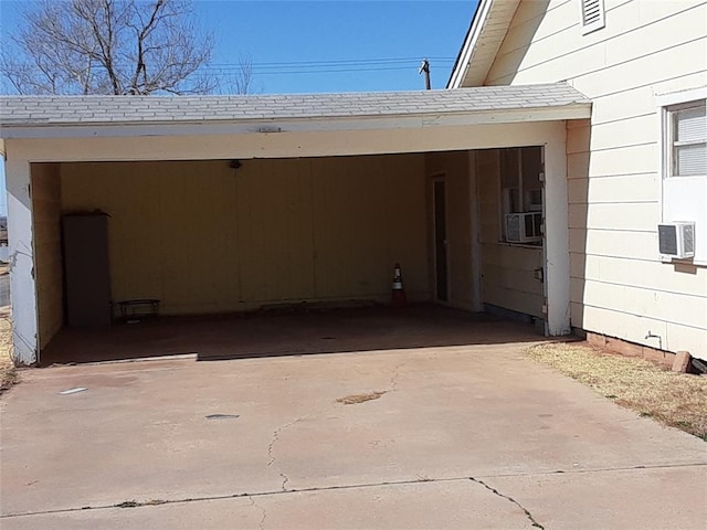 view of parking / parking lot featuring cooling unit and driveway