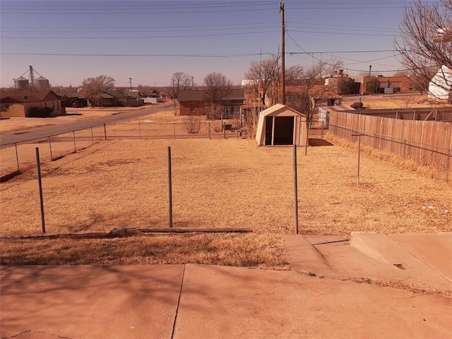 view of yard with a fenced backyard and an outdoor structure