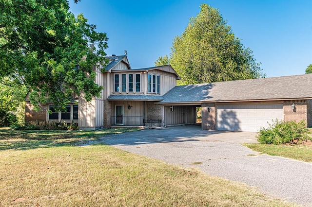 view of front of house featuring a front yard and a garage