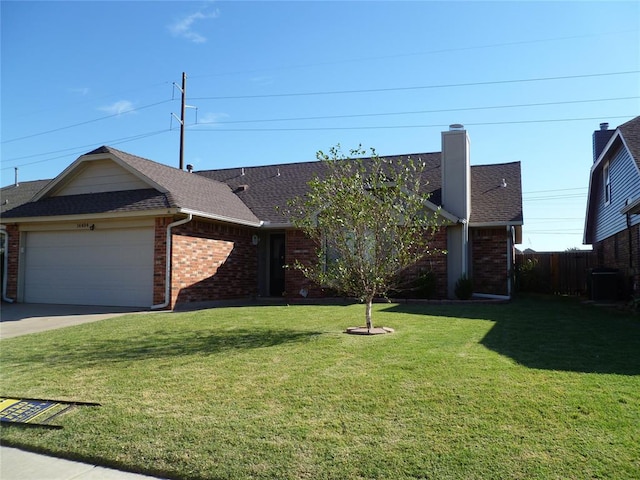 ranch-style house featuring a garage and a front yard